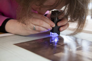 Permalink to Getty Voices: Be a Photograph Sleuth Miriam looks through her handy magnifying glass and light to try to determine the photographic process of this image.