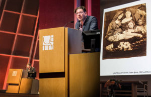 Permalink to Artists, Educators, and Curators on L.A. and Photography George Baker, professor of art history at UCLA, offering the keynote address. On screen: photograph by Julia Margaret Cameron