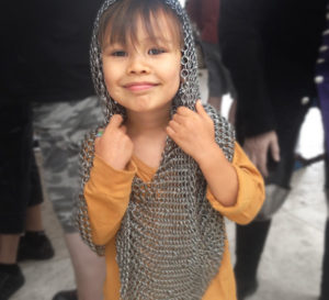 Permalink to A Curator “Visits” the Getty A child dressed in chain mail at a Getty Center family festival