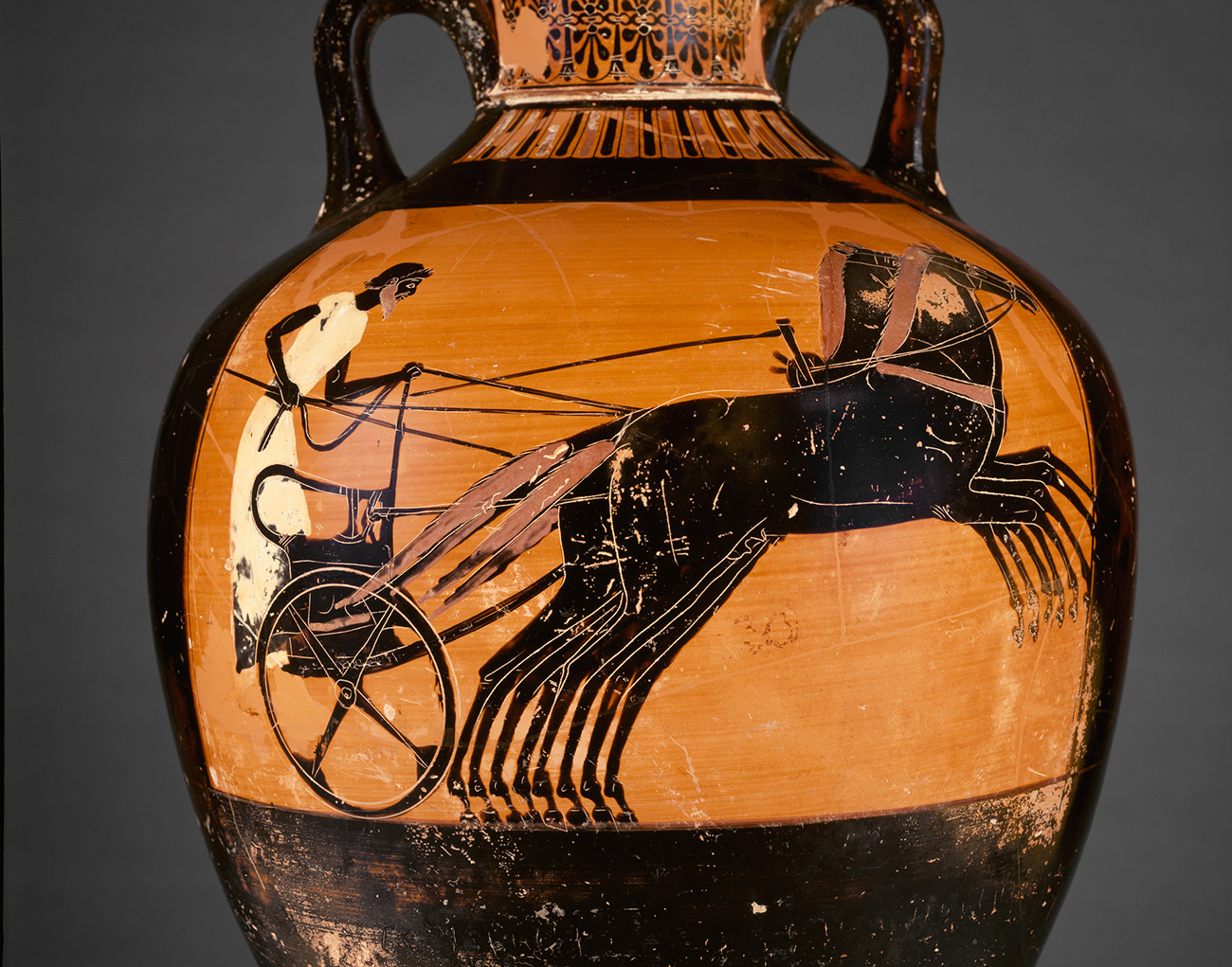 Vase painting showing a charioteer racing to victory in a four-horse chariot