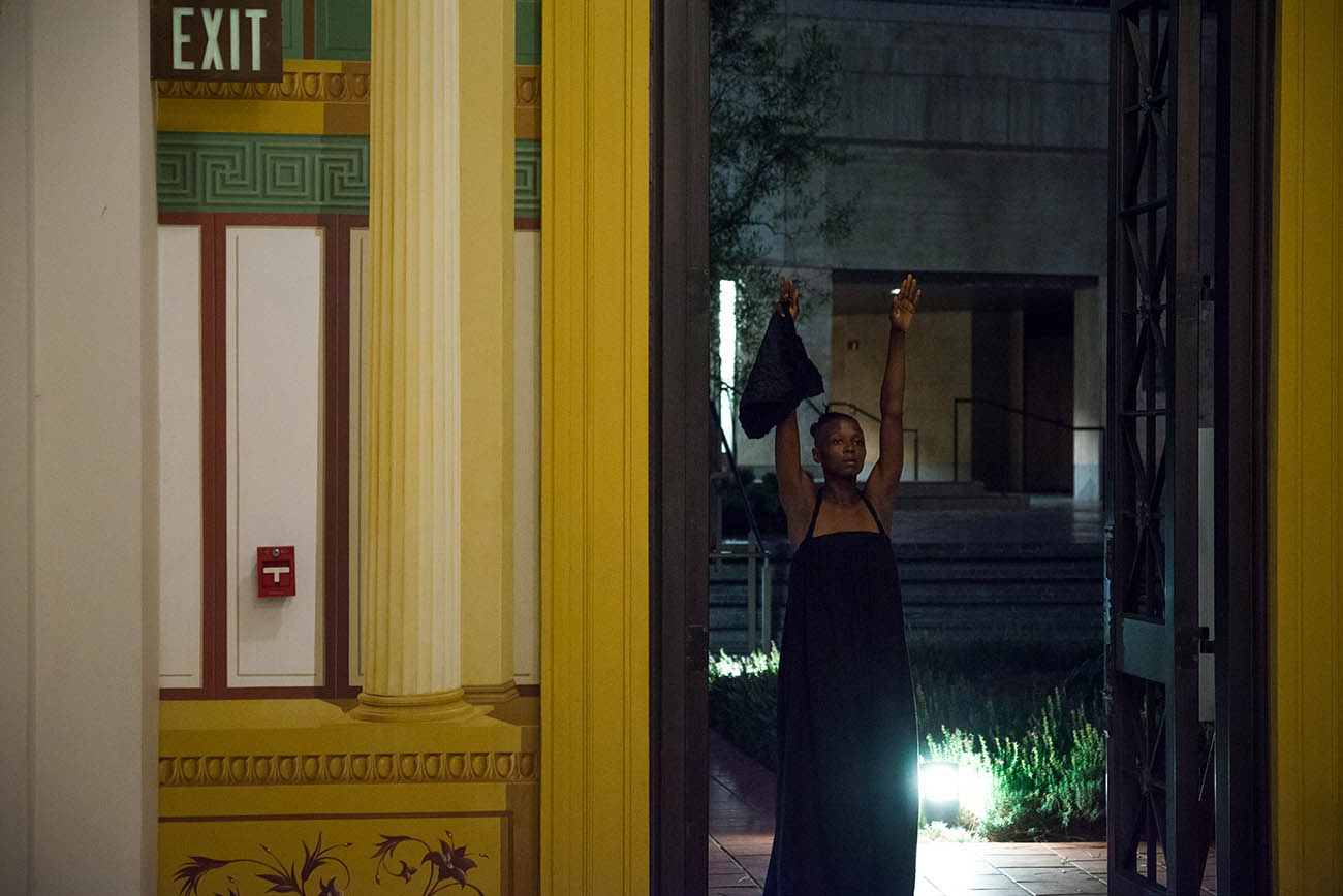 With arms raised, taisha pagget dances in the Getty Villa's Outer Peristyle Garden. With arms raised, taisha pagget dances in the Getty Villa's Outer Peristyle Garden.